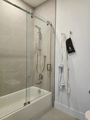 a bathroom with a shower and bathtub