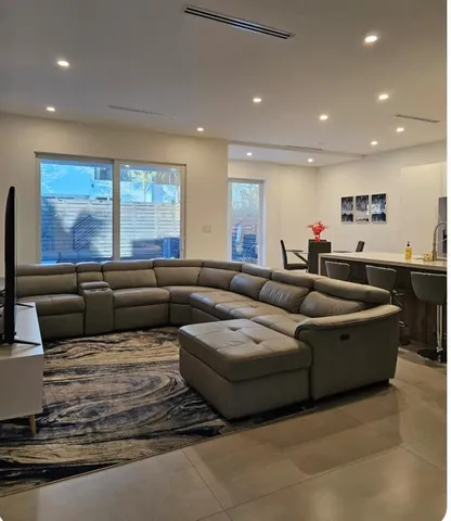 a living room with furniture wooden floor and a flat screen tv