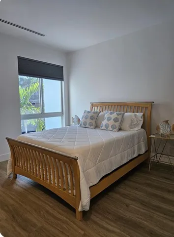 a bedroom with a bed and window