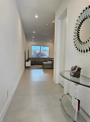 a view of a kitchen with kitchen island stainless steel appliances a sink and a stove