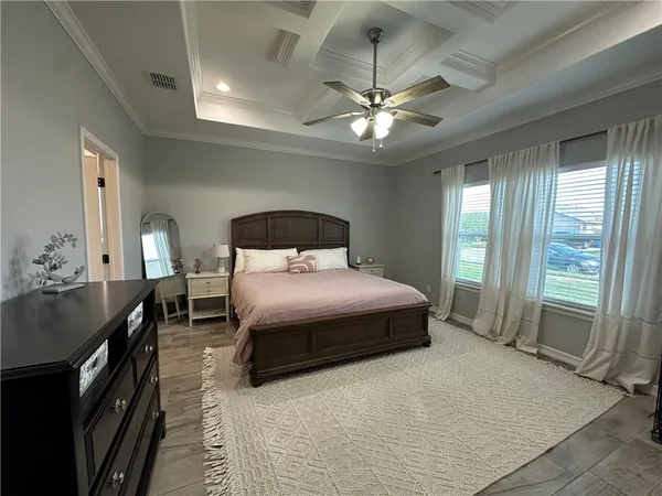 a bedroom with a bed and a chandelier