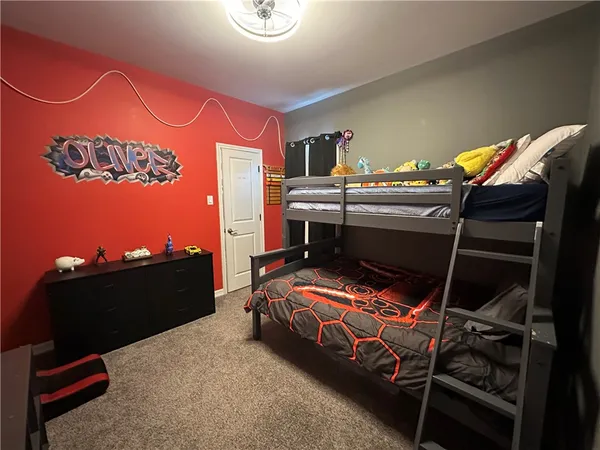 a living room with furniture flat screen tv and wall paintings