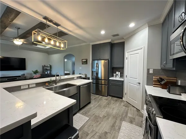 a kitchen with a refrigerator a sink and cabinets