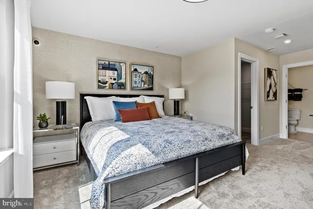 a bedroom with a bed and a lamp on table