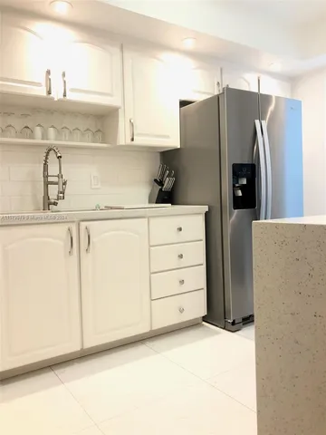 a bedroom with a bed and a night stand