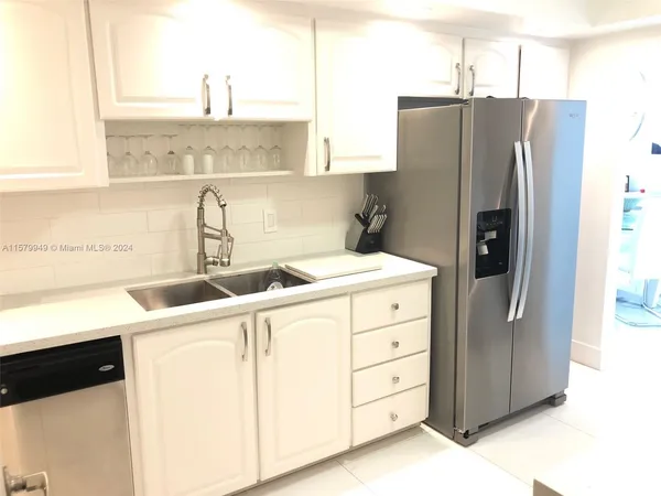 a large bed sitting in a bedroom next to a lamp