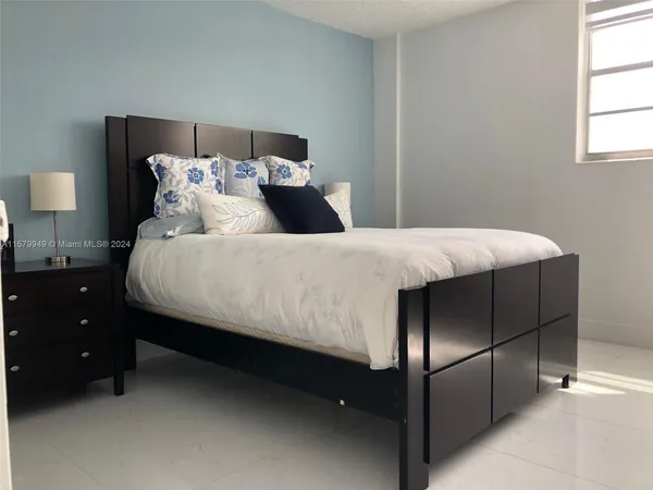 a living room with furniture a potted plant and a table