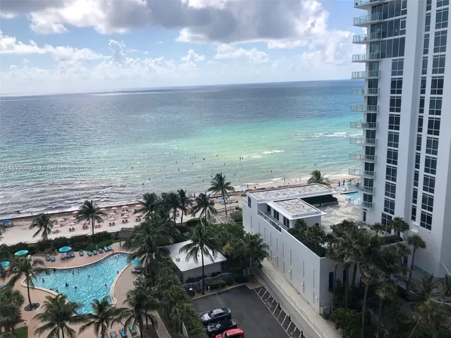 a group of people sitting in front of a house