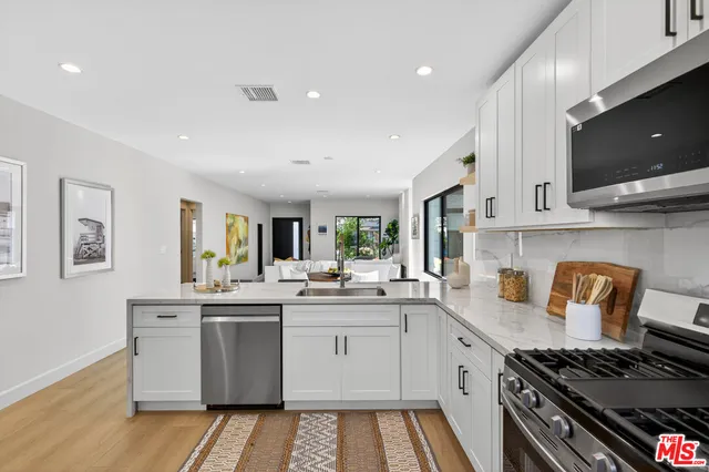 a kitchen with a sink stove and microwave