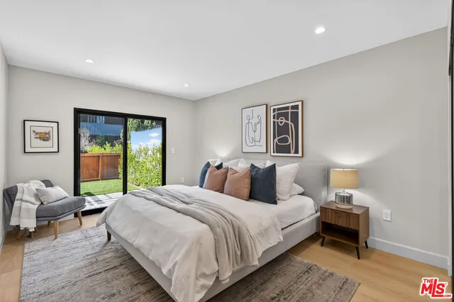 a large bedroom with a bed and a couch