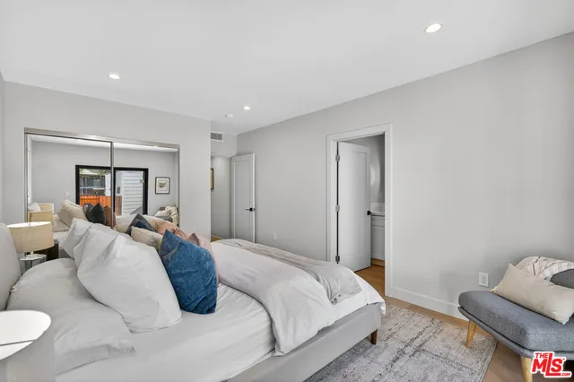 a bedroom with a bed and a couch