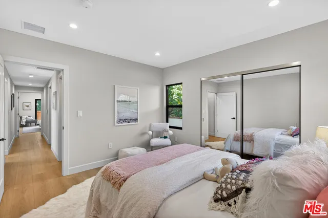a bedroom with two beds and a chandelier