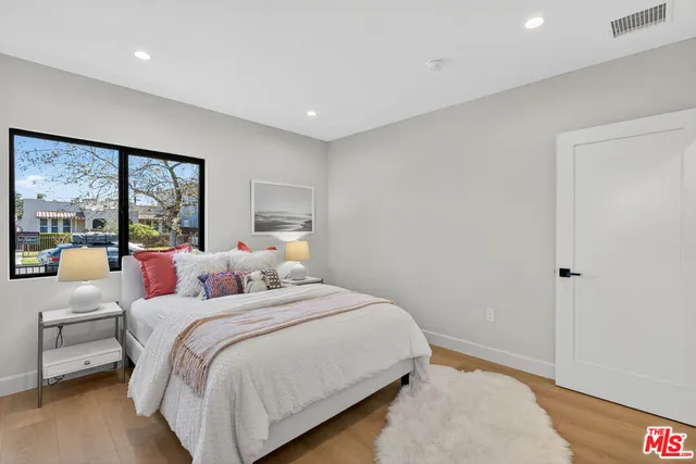 a bedroom with a large bed and a large window