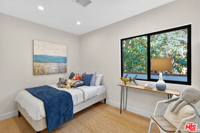 a bedroom with a large bed and a large window