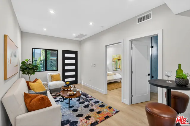 a kitchen with stainless steel appliances granite countertop a sink a stove oven and white cabinets