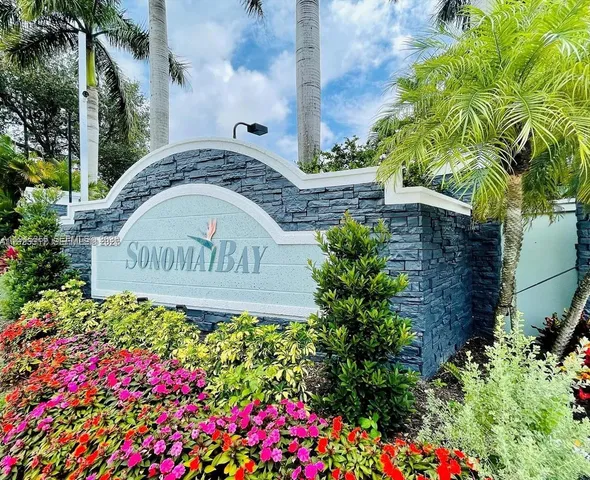 a sign that is sitting in front of flowers