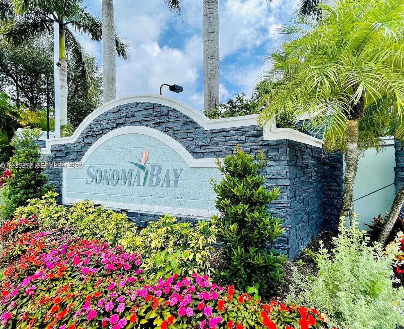 a sign that is sitting in front of flowers