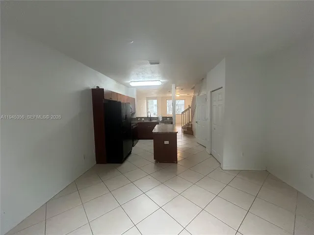 a room with a refrigerator and a stove