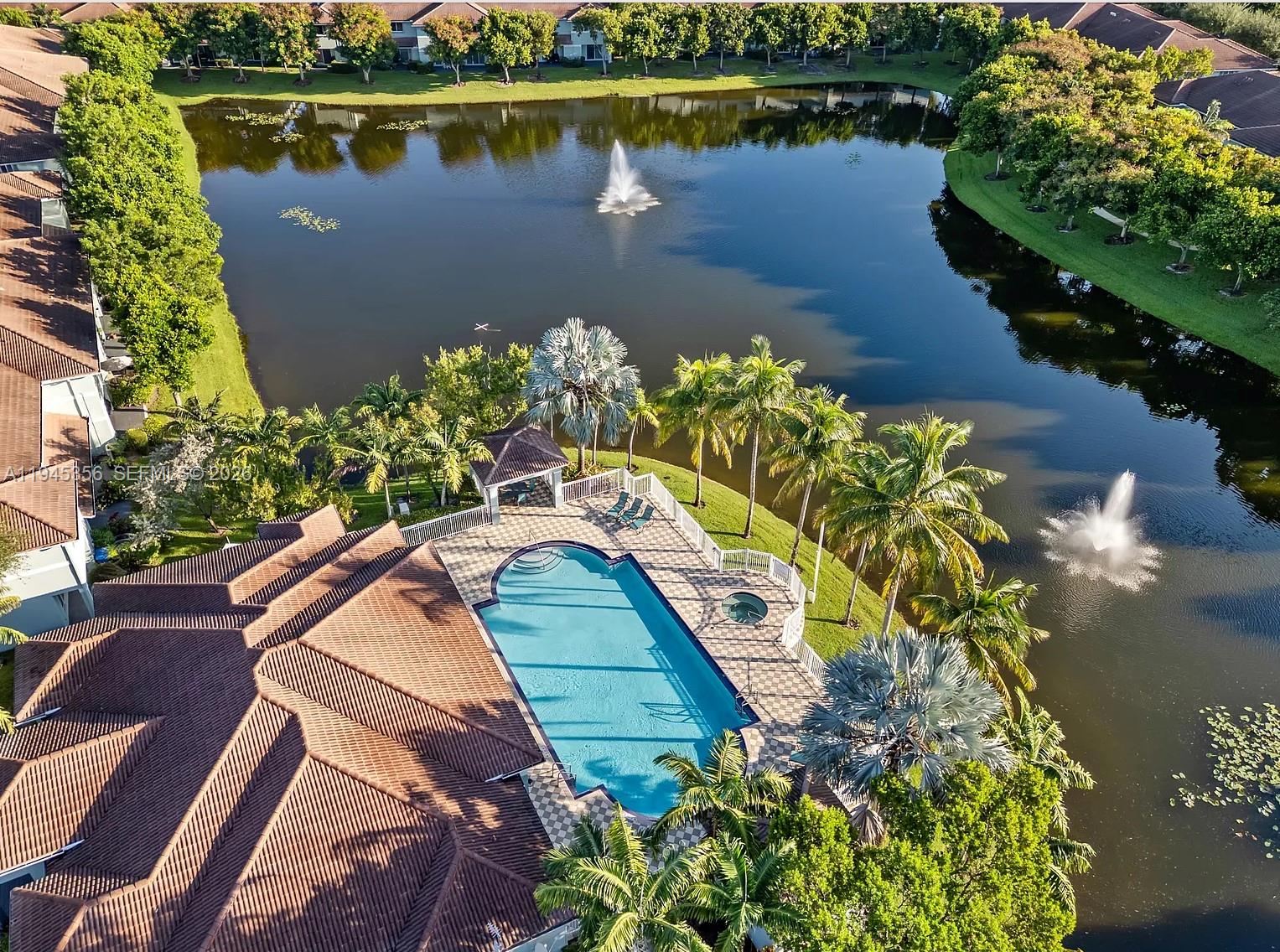 1916 Alamanda Way Riviera Beach, FL 33404 - Photo 2 of 22 a view of a lake with a building in the background