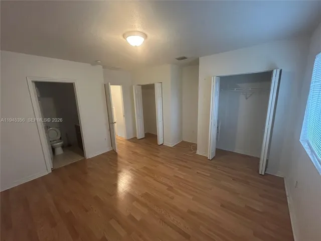 a bathroom with a double vanity sink toilet and shower