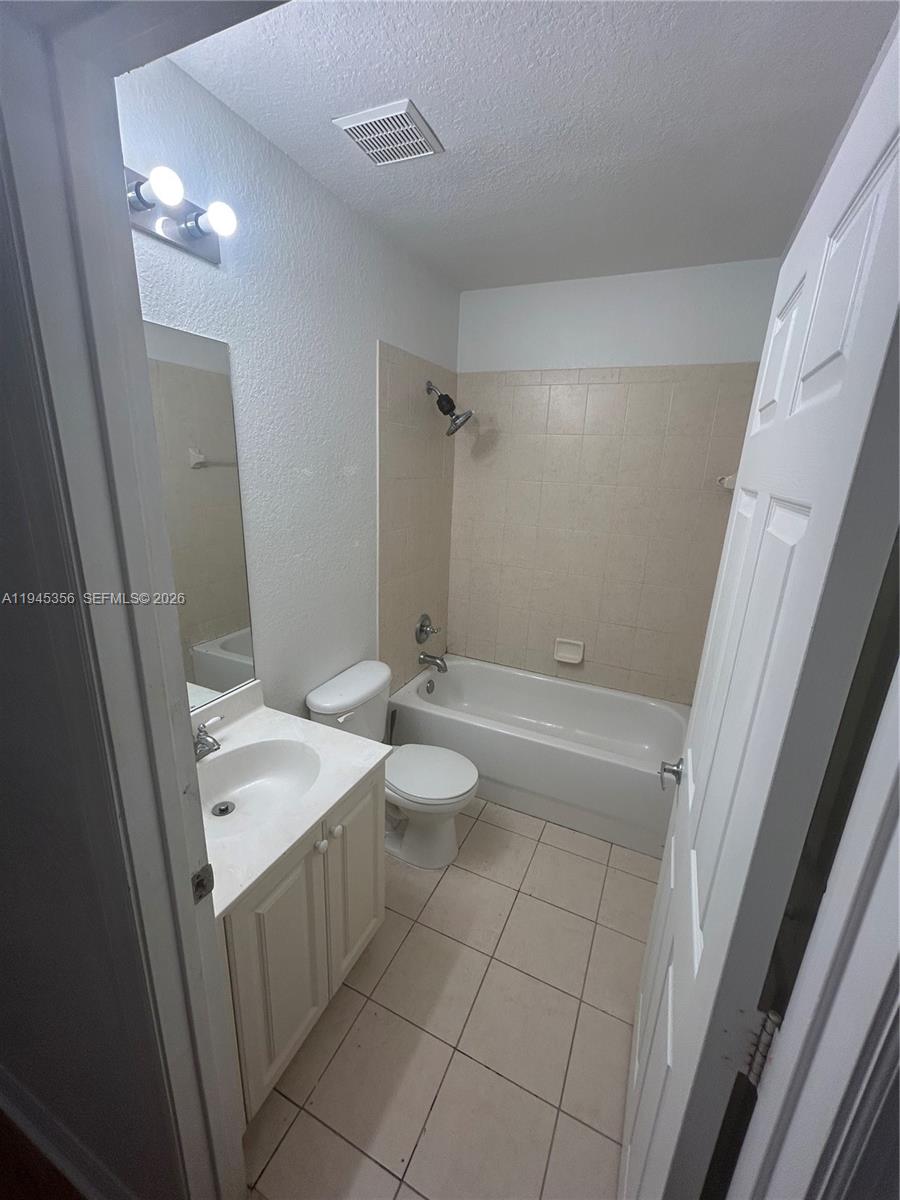 1916 Alamanda Way Riviera Beach, FL 33404 - Photo 22 of 22 a bathroom with a double vanity sink toilet and shower