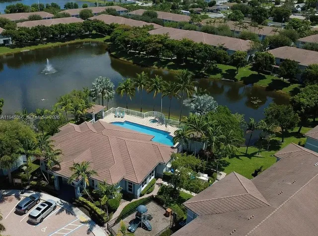 an aerial view of a house with outdoor space and lake view