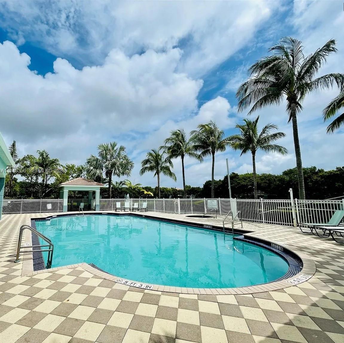 1916 Alamanda Way Riviera Beach, FL 33404 - Photo 4 of 22 a view of a swimming pool with a lounge chair