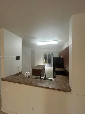 a view of a living room and kitchen