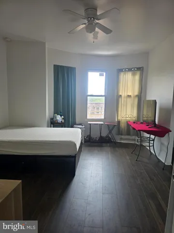 a bedroom with a bed chair and window