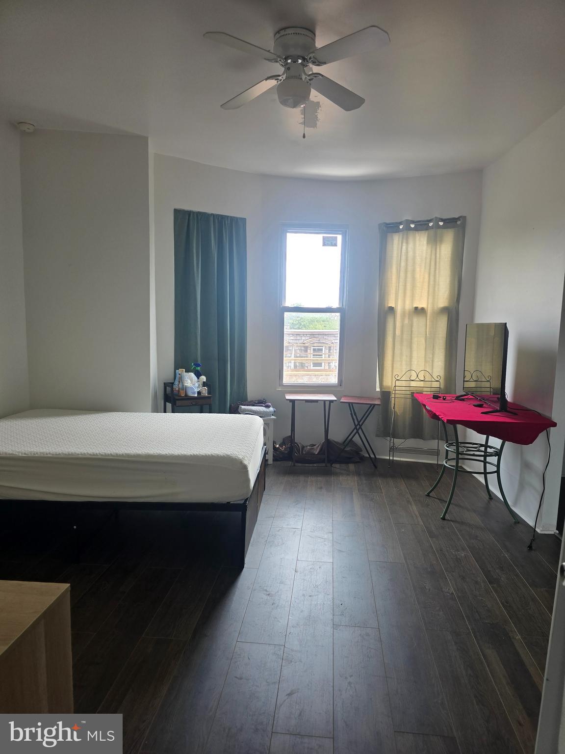 a bedroom with a bed chair and window