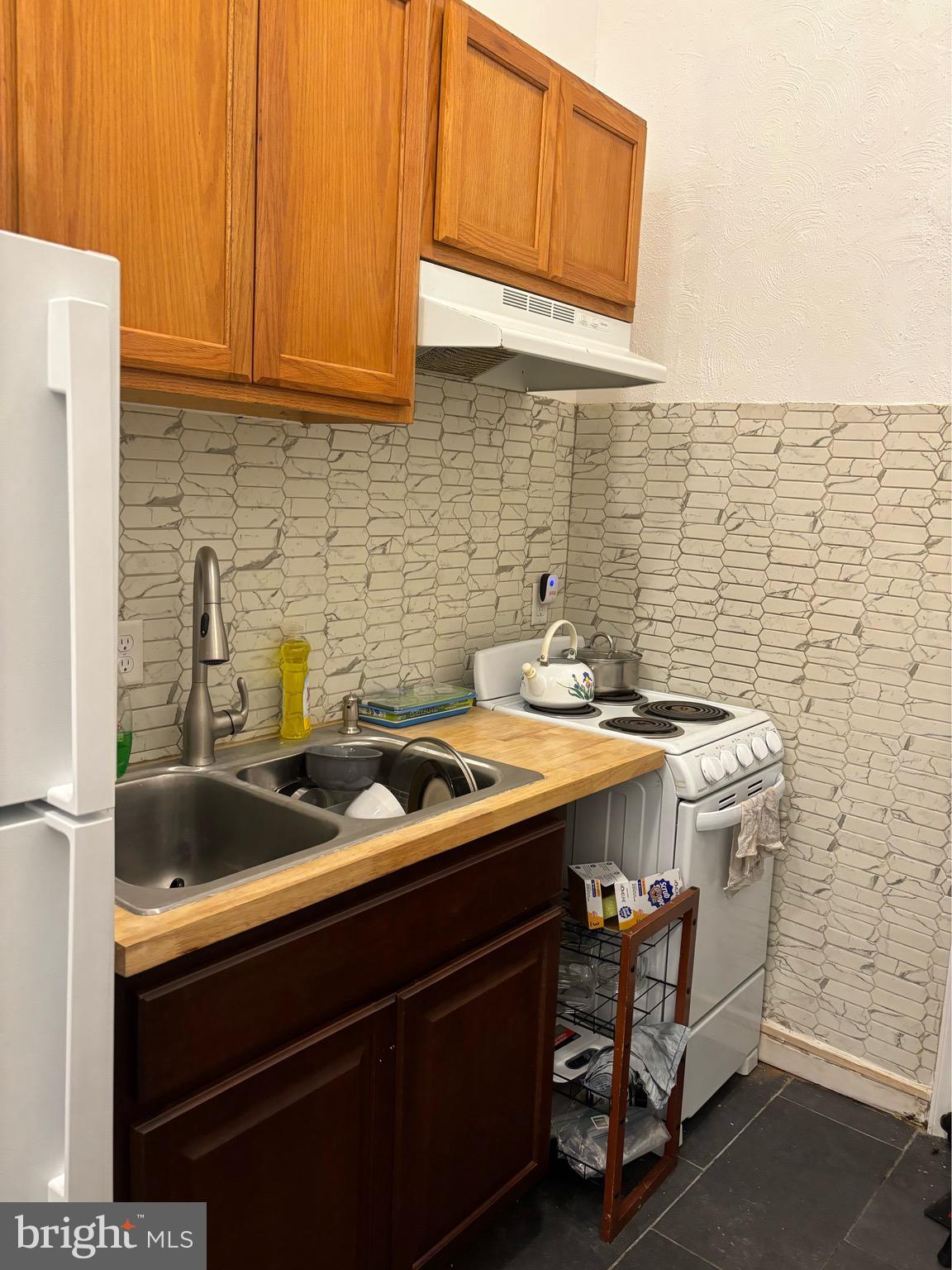 4328 Frankford Avenue, Unit 2A Philadelphia, PA 19124 - Photo 12 of 20 a kitchen with a sink cabinets and stainless steel appliances