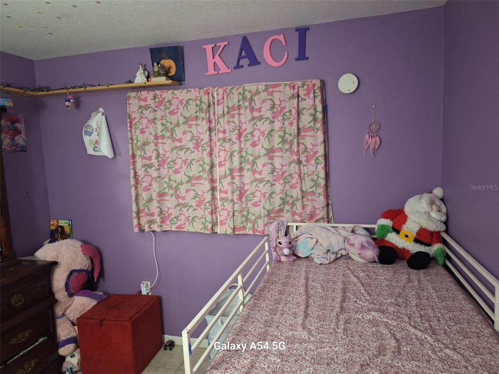 3762 Southwest 150th Loop Ocala, FL 34473 - Photo 15 of 25 a bedroom with a bed and hallway