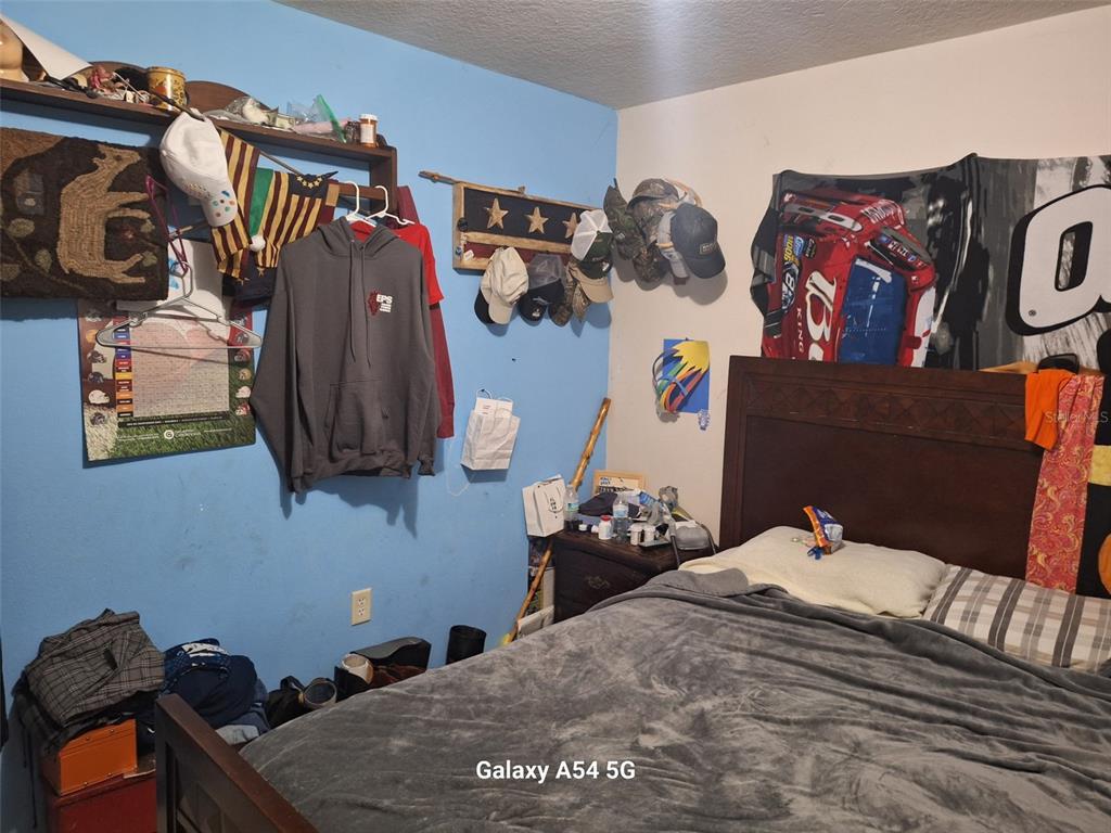 3762 Southwest 150th Loop Ocala, FL 34473 - Photo 16 of 25 a bedroom with a bed and dresser