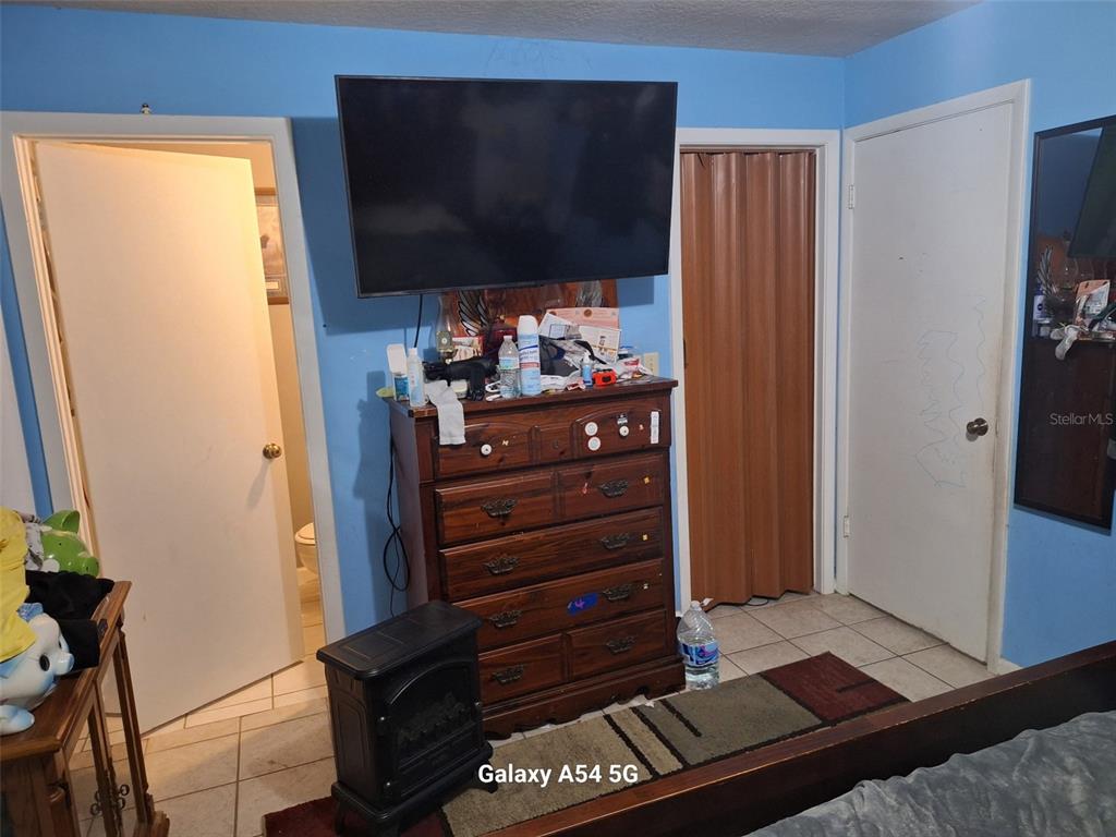 3762 Southwest 150th Loop Ocala, FL 34473 - Photo 17 of 25 a room with wooden floor and furniture