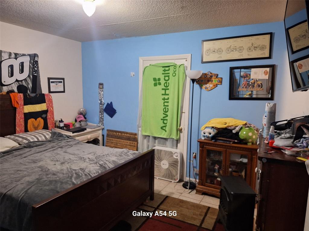 3762 Southwest 150th Loop Ocala, FL 34473 - Photo 20 of 25 a bedroom with bed and a mirror