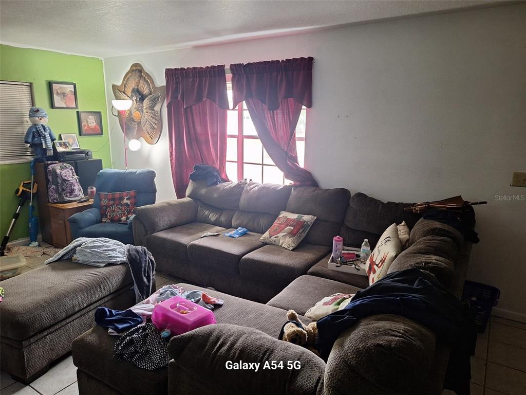 3762 Southwest 150th Loop Ocala, FL 34473 - Photo 2 of 25 a living room with furniture and a window