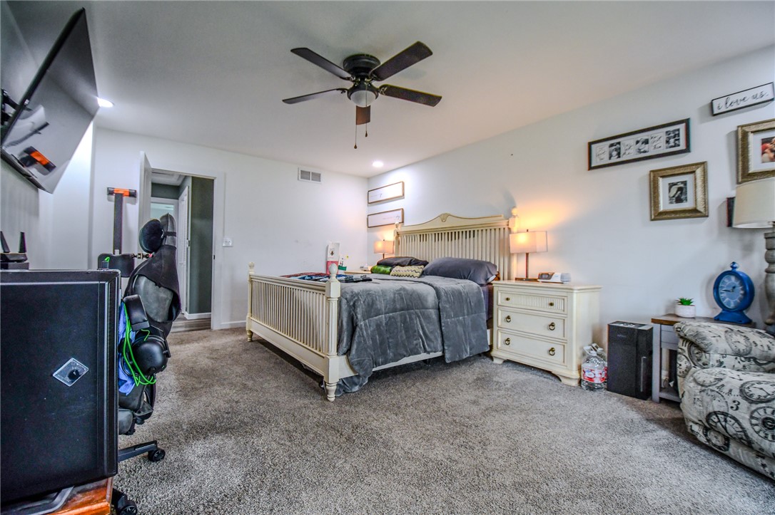 6169 Dayton Farmersville Road Dayton, OH 45417 - Photo 27 of 64 This cozy bedroom features a ceiling fan, plush carpeting, and warm lighting, creating a comfortable retreat.