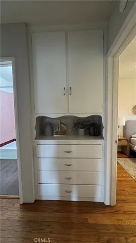 a view of dresser and wooden floor