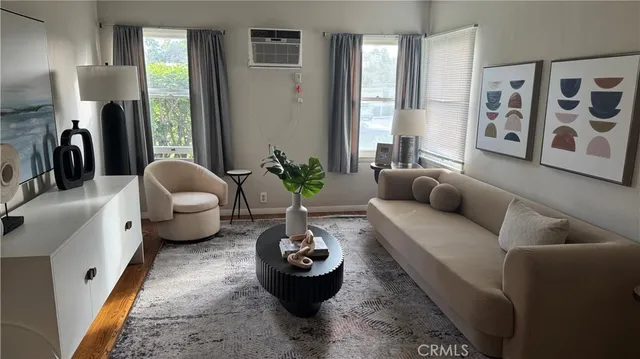 a living room with furniture and a large window