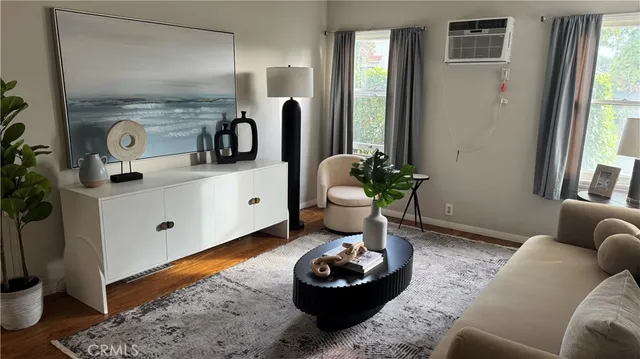 a living room with furniture and a potted plant