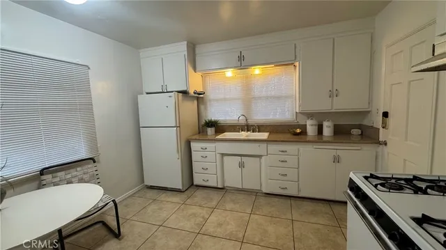 a kitchen with a sink stove and refrigerator