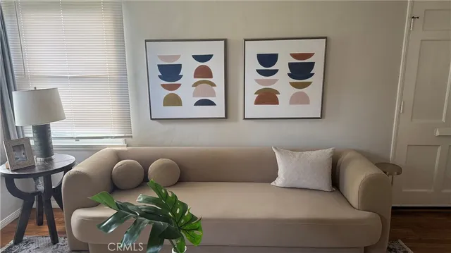 a living room with furniture and wall paintings