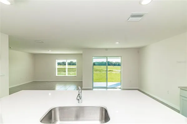a view of a kitchen with a sink and a window