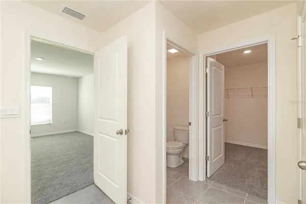 a spacious bathroom with a shower sink and mirror