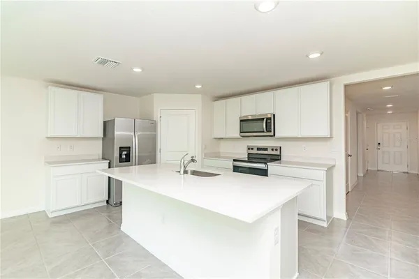 a kitchen with stainless steel appliances a stove sink and refrigerator