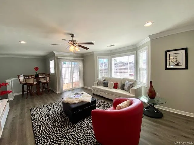 a living room with furniture two window and a table