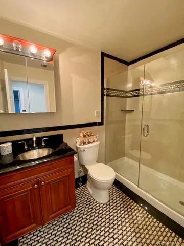 a bathroom with a sink toilet a mirror and shower