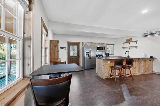 a kitchen with stainless steel appliances granite countertop a sink stove and microwave
