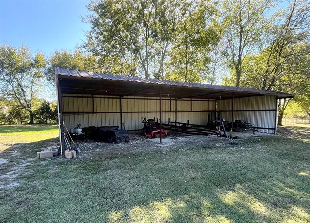 a view of backyard with swimming pool and sitting area