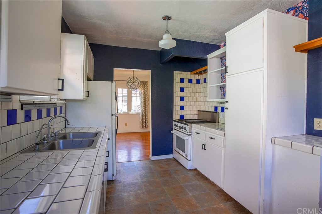 2537 Devonshire Lane Altadena, CA 91001 - Photo 10 of 23 a kitchen with stainless steel appliances a refrigerator and a stove top oven